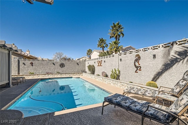 view of swimming pool featuring a patio area, a fenced backyard, and a fenced in pool