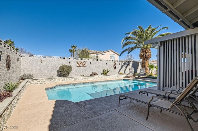 view of swimming pool with a fenced in pool, a fenced backyard, and a patio