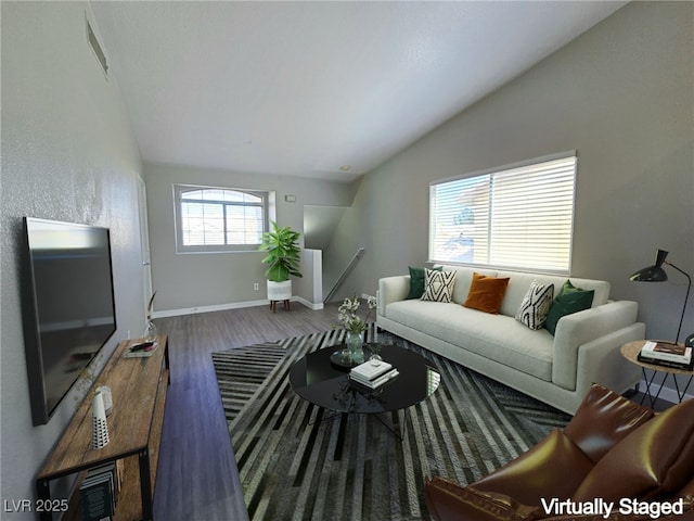 living room with vaulted ceiling, wood finished floors, and baseboards