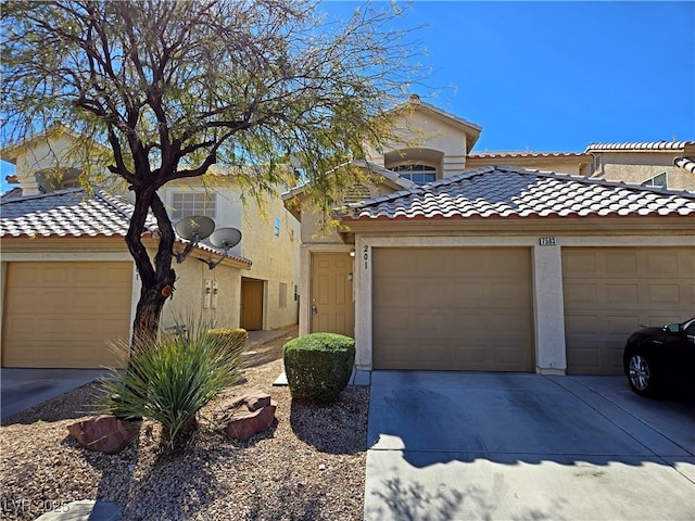 mediterranean / spanish-style house featuring driveway, a tile roof, a garage, and stucco siding