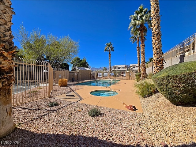 community pool featuring a fenced backyard and a patio