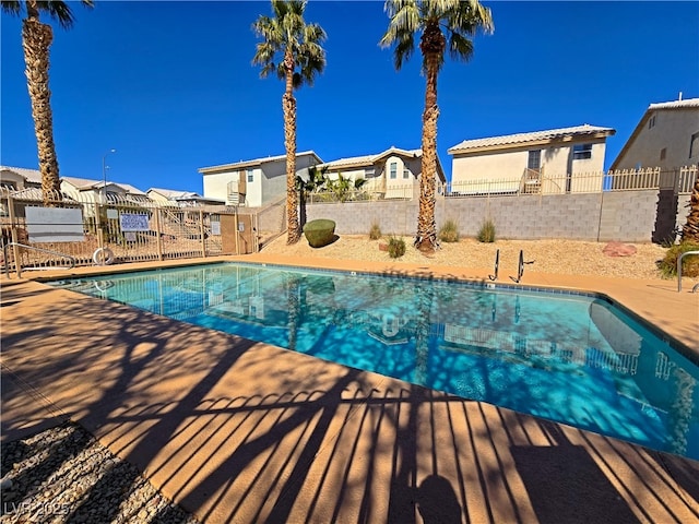 view of pool with a patio, a residential view, a fenced backyard, and a fenced in pool