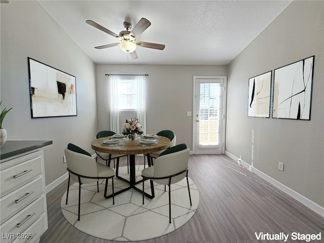 dining room with baseboards, wood finished floors, and a healthy amount of sunlight