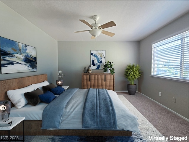 carpeted bedroom featuring ceiling fan, a textured ceiling, and baseboards