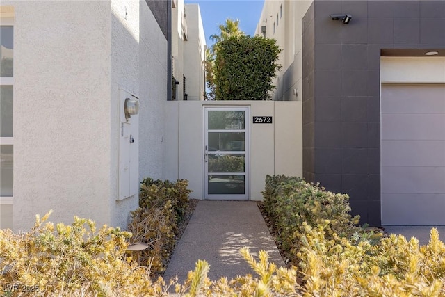 property entrance featuring stucco siding