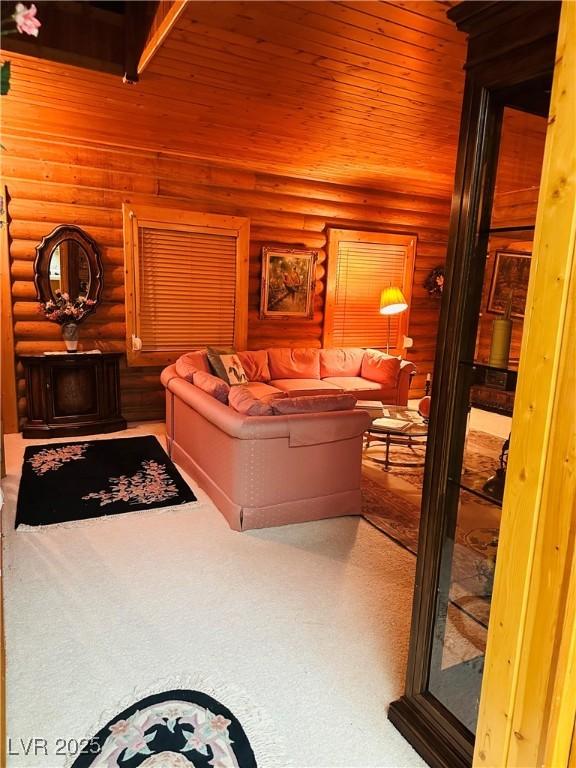 bedroom featuring wooden ceiling and log walls