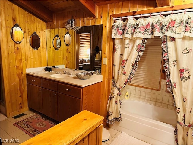 full bathroom with wooden walls, visible vents, tile patterned floors, beamed ceiling, and shower / bath combo with shower curtain