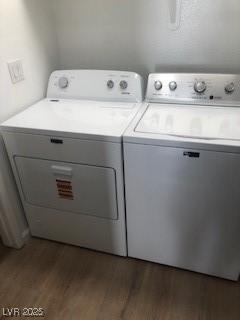 clothes washing area with laundry area, dark wood-style flooring, and washing machine and dryer