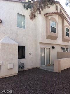 back of property featuring stucco siding