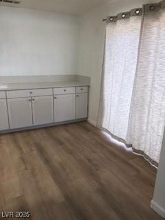 unfurnished dining area featuring wood finished floors