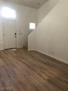 foyer featuring wood finished floors and baseboards