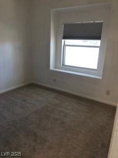 unfurnished room with carpet and baseboards