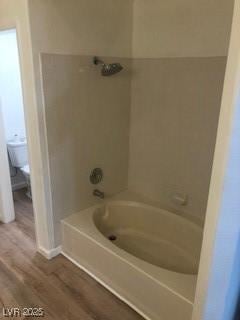 full bathroom with tub / shower combination and wood finished floors