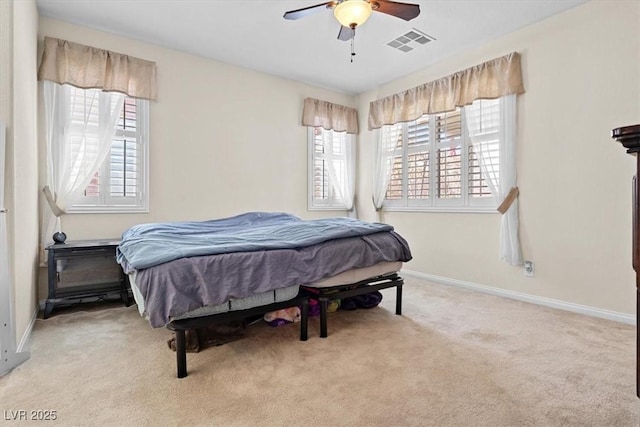 carpeted bedroom featuring visible vents, ceiling fan, and baseboards