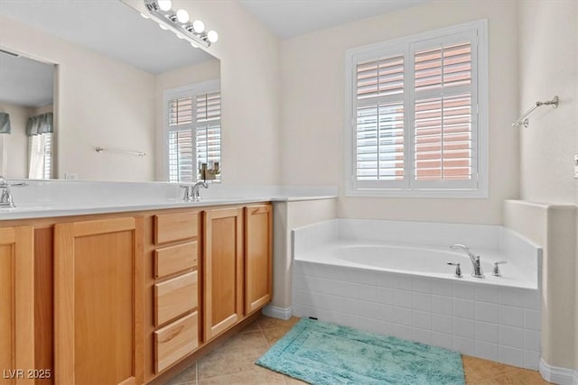 bathroom with a garden tub, double vanity, a sink, and tile patterned floors