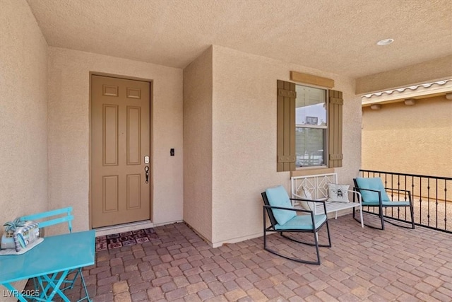 view of exterior entry with stucco siding