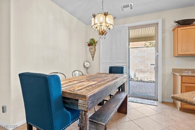 dining space with light tile patterned floors, baseboards, visible vents, and a chandelier