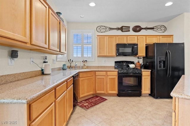 kitchen featuring light stone counters, recessed lighting, light brown cabinetry, a sink, and black appliances