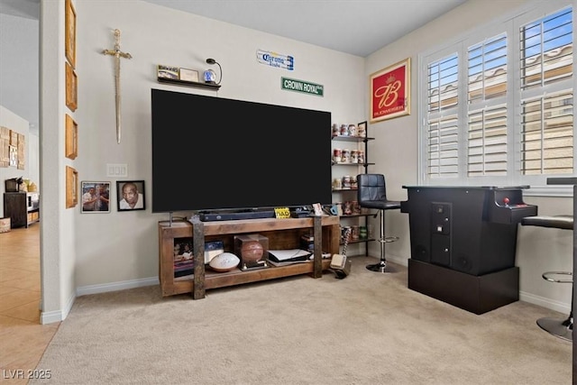 carpeted office space featuring plenty of natural light and baseboards