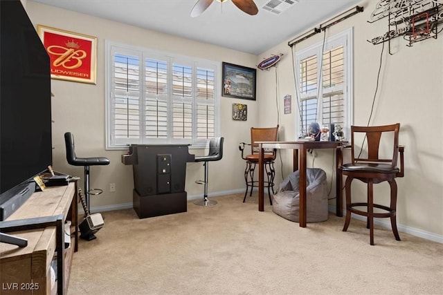 carpeted office with a ceiling fan, visible vents, and baseboards