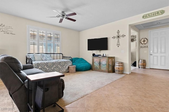 carpeted living room with ceiling fan, baseboards, and tile patterned floors