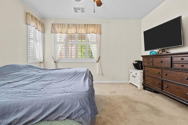 bedroom featuring a ceiling fan, light carpet, visible vents, and baseboards