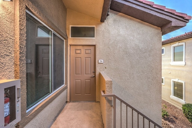 entrance to property with stucco siding