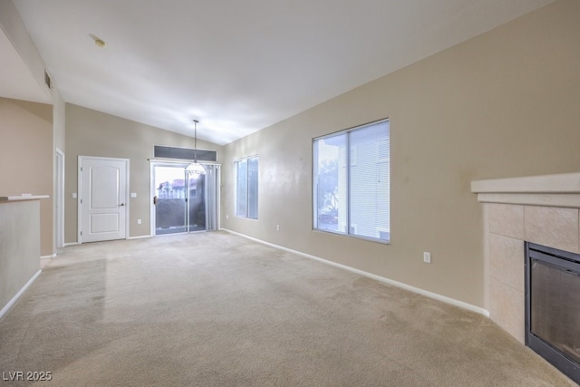 unfurnished living room with light carpet, visible vents, baseboards, a tiled fireplace, and vaulted ceiling