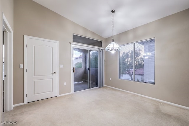 interior space featuring a chandelier, baseboards, vaulted ceiling, and light colored carpet