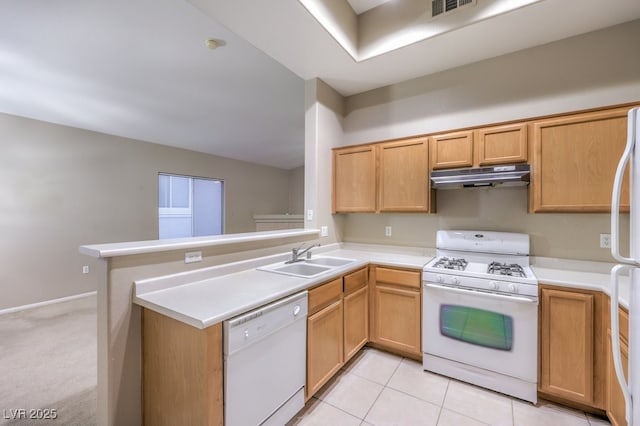 kitchen with light countertops, a sink, a peninsula, white appliances, and under cabinet range hood