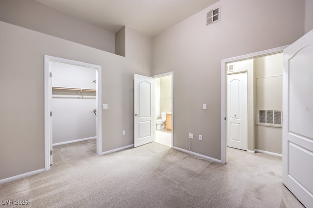 unfurnished bedroom with light colored carpet, visible vents, and baseboards