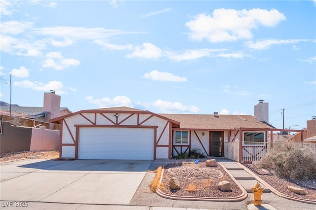 view of front of house featuring an attached garage, fence, concrete driveway, and stucco siding