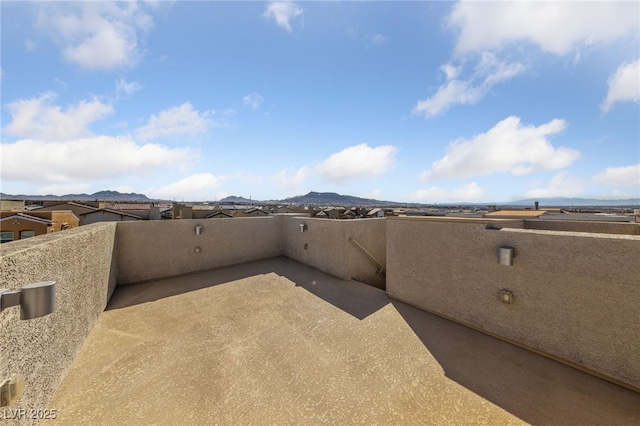 view of patio featuring a mountain view and a balcony