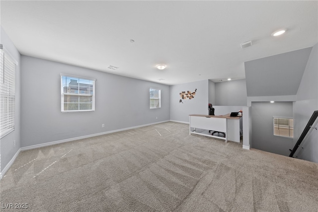 unfurnished living room with carpet flooring, visible vents, and baseboards