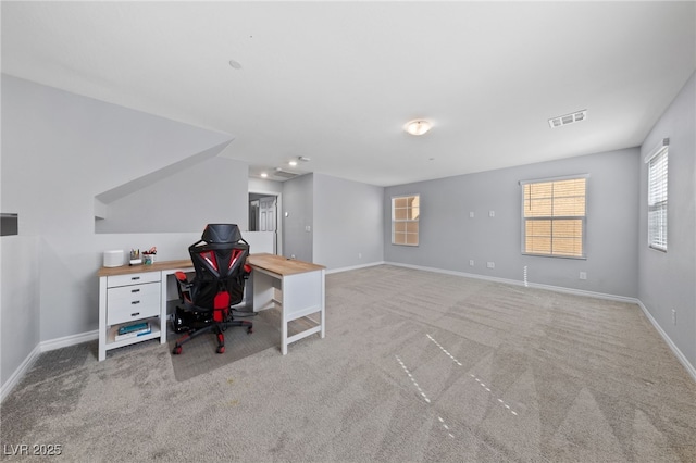 office space featuring carpet flooring, visible vents, and baseboards