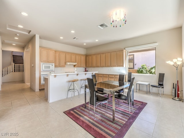 dining room featuring baseboards, light tile patterned flooring, visible vents, and recessed lighting