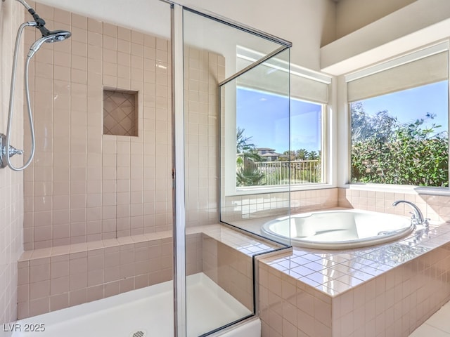 bathroom featuring a garden tub and a stall shower
