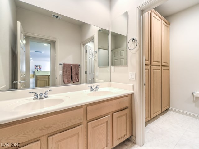 bathroom featuring tile patterned floors, double vanity, a sink, and visible vents
