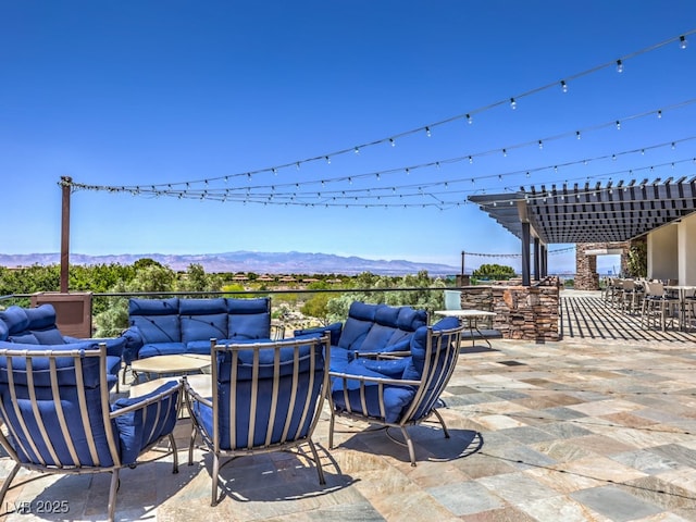view of patio / terrace featuring a mountain view, an outdoor hangout area, and a pergola