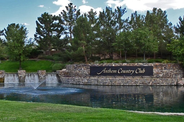 view of property's community featuring a water view and a lawn