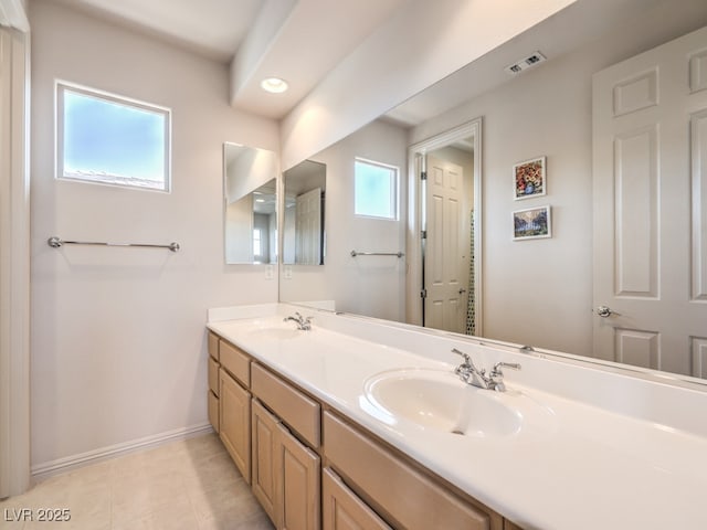 full bathroom with visible vents, a sink, tile patterned floors, double vanity, and baseboards
