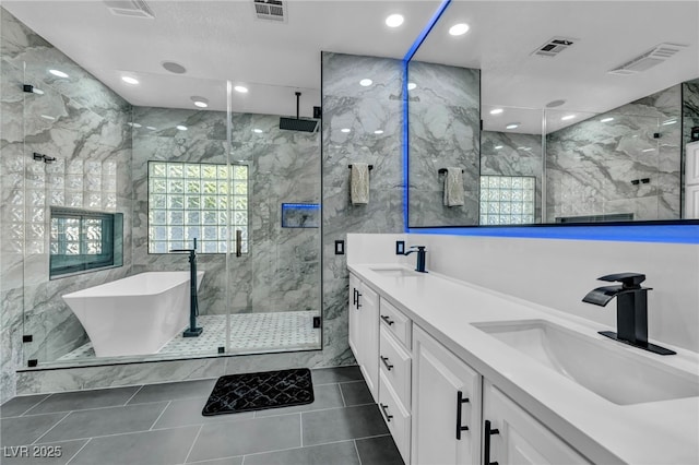 full bathroom with a stall shower, visible vents, and a sink