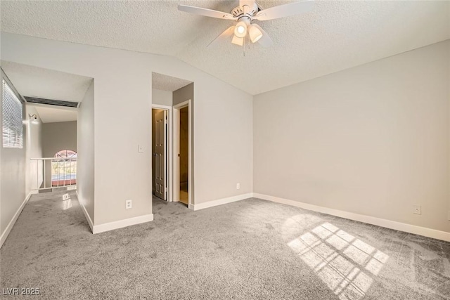 unfurnished bedroom featuring visible vents, baseboards, lofted ceiling, a textured ceiling, and carpet flooring