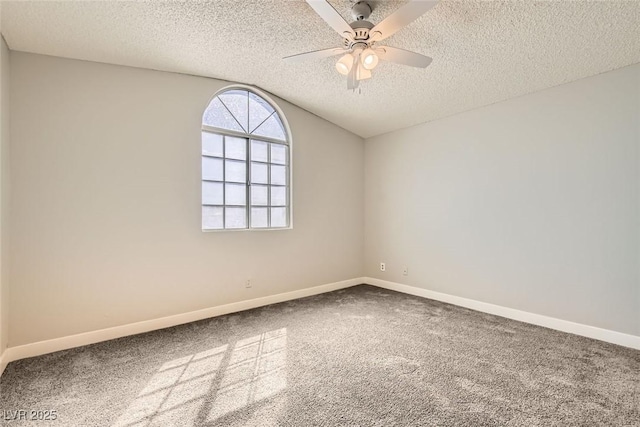 carpeted spare room with lofted ceiling, ceiling fan, a textured ceiling, and baseboards