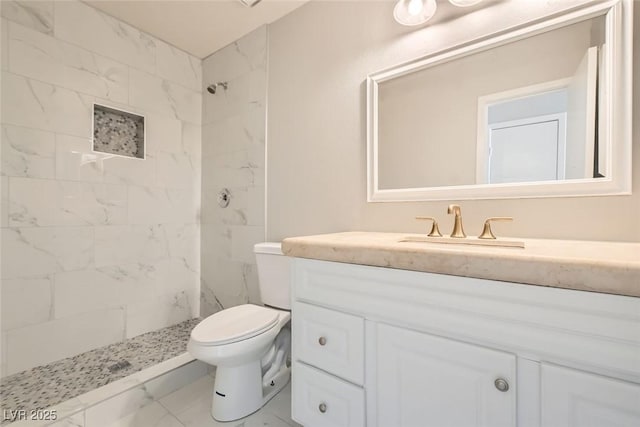 full bathroom featuring marble finish floor, tiled shower, vanity, and toilet