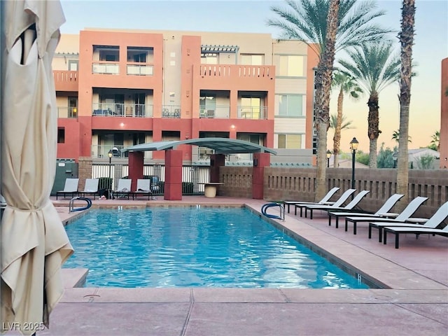 view of swimming pool with a patio area and fence