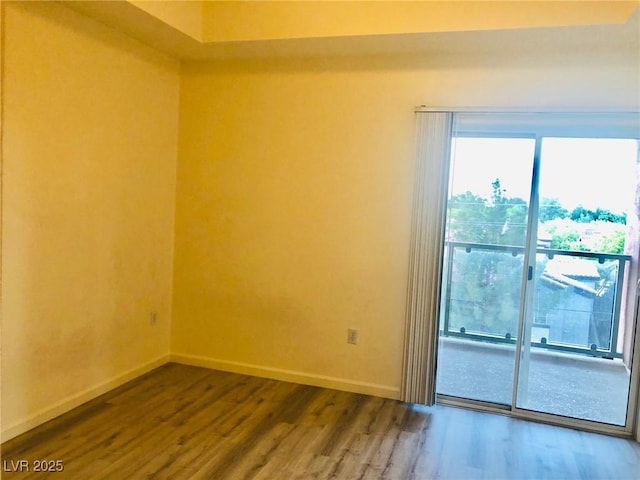 empty room with baseboards and wood finished floors