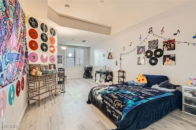 bedroom with baseboards and wood finished floors