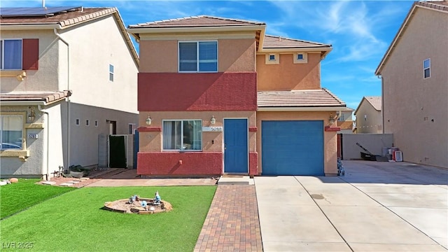 view of front of house with driveway, a garage, stucco siding, a tiled roof, and a front yard