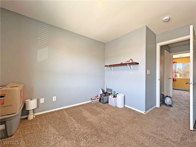 interior space with carpet floors and baseboards